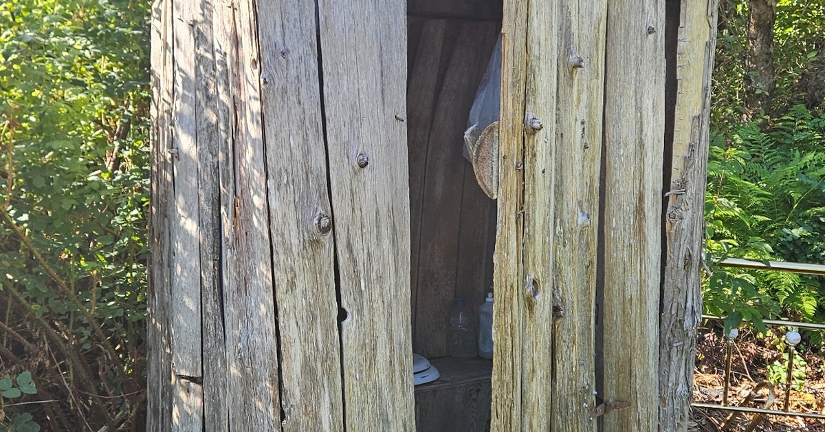 Old deteriorating outhouse before demolition and new build on Kilbrennan Lake Road in Troy Montana